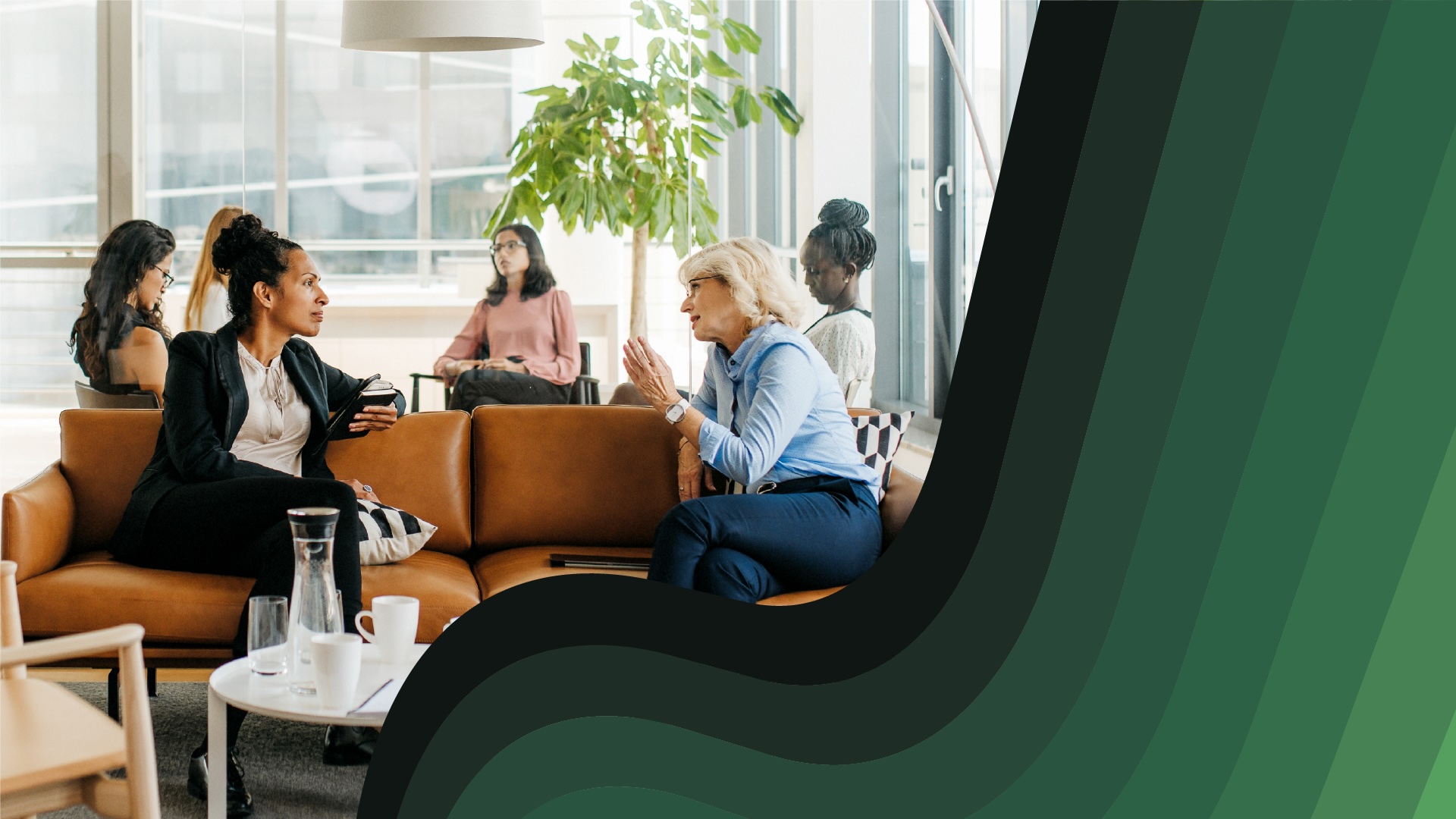 Professional women chat in an office lounge