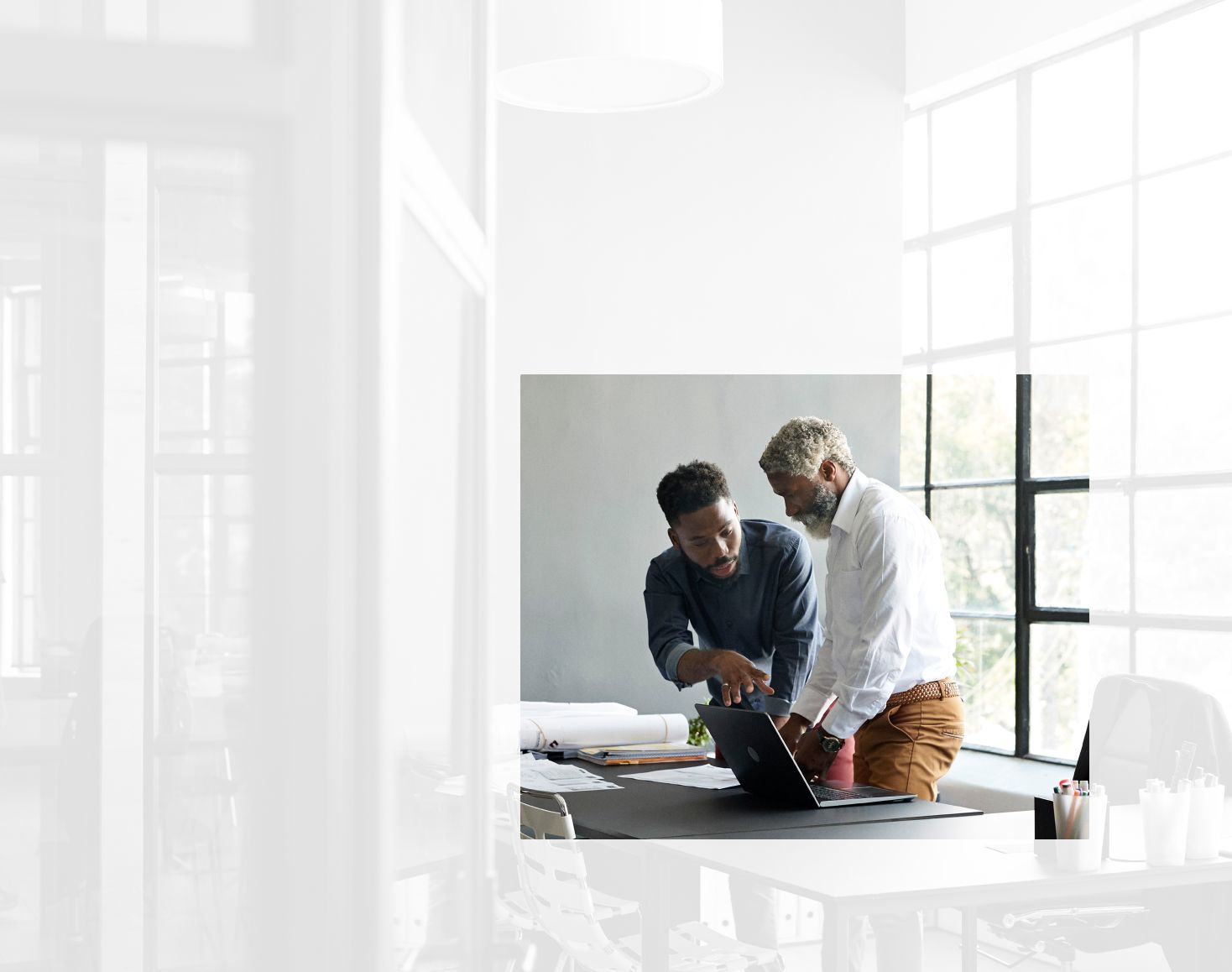 Two men discussing business during a meeting. The immediate area surrounding them is highlighted for a photo crop.